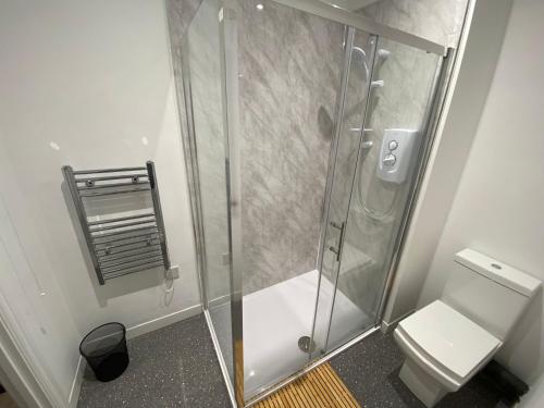 a shower stall in a bathroom with a toilet at Maritime House One - Hull in Hull
