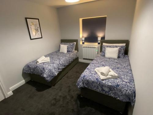 a room with two beds and a mirror at Maritime House One - Hull in Hull