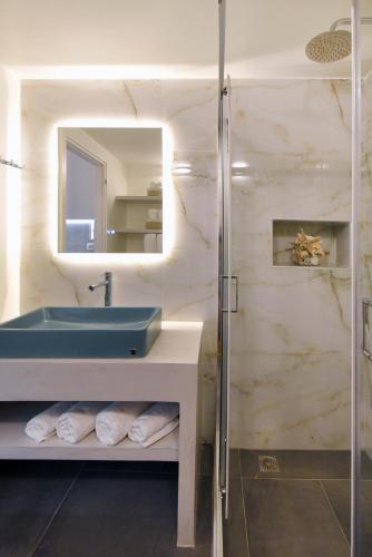 a bathroom with a blue sink and a mirror at Ledio's house in Ermoupoli