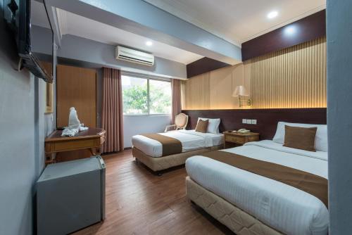 Llit o llits en una habitació de Grand Orchard Hotel Premier