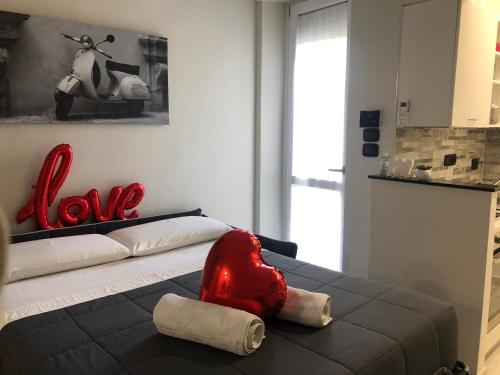 a room with a bed with a red stuffed animal on it at Maremma10 in Turin