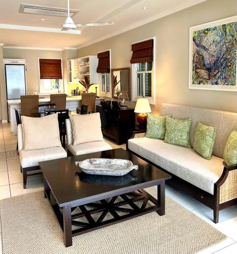 a living room with a couch and a coffee table at Eden Island Luxury Accommodation in Eden Island