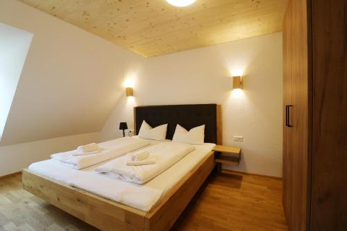 sypialnia z dużym łóżkiem z białą pościelą w obiekcie Tannenhof Fischbach - Fewo 4 "Hecht" - Schluchsee, 4 Schlafzimmer w mieście Schluchsee