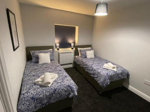 a bedroom with two beds with towels on them at Maritime House Two in Hull