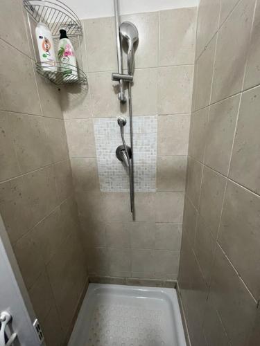 a shower stall with a shower head and a tub at Da Rosaria in Naples