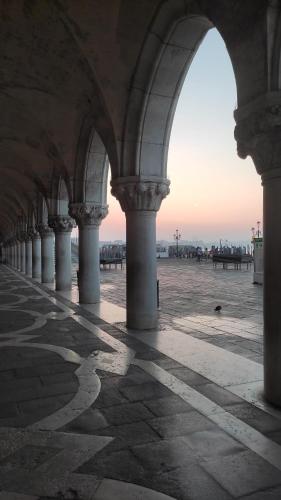 a building with columns and a view of the ocean at Hotel Bridge in Venice