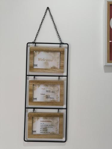 a display of wooden frames hanging on a wall at Suitel Pombal in Pombal