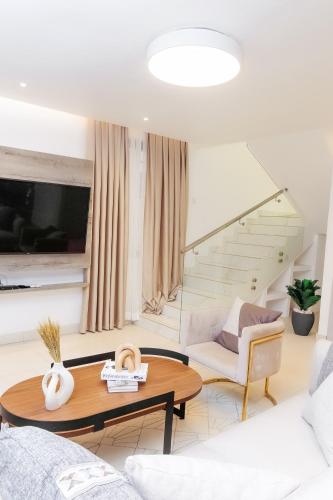 a living room with a table and a couch at Luna Loft in Tema