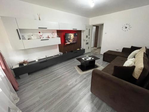 a living room with a couch and a table at AKY Residence in Slănic-Moldova