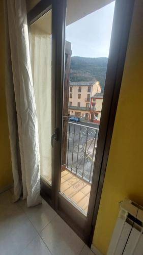 an open door to a balcony with a view at Hostal Rural Sositana in Castejón de Sos