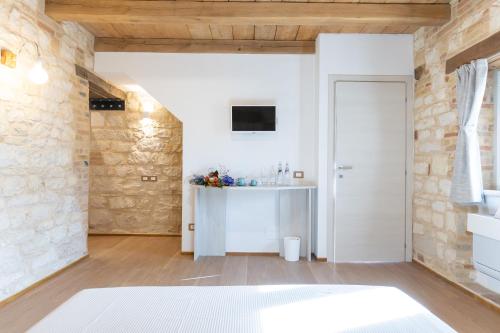 a living room with a stone wall at Il Fiore del Conero in Sirolo