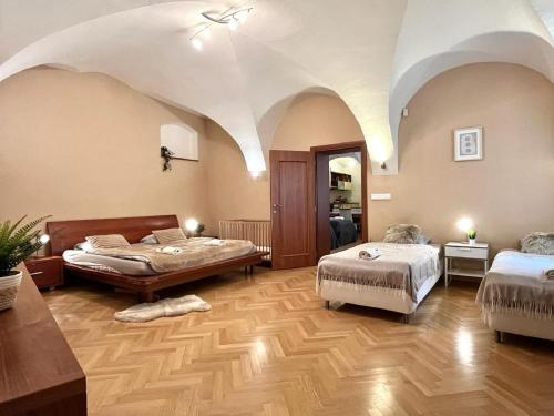 a bedroom with two beds in a room with a ceiling at Apartment Sophie - Old Town in Bratislava