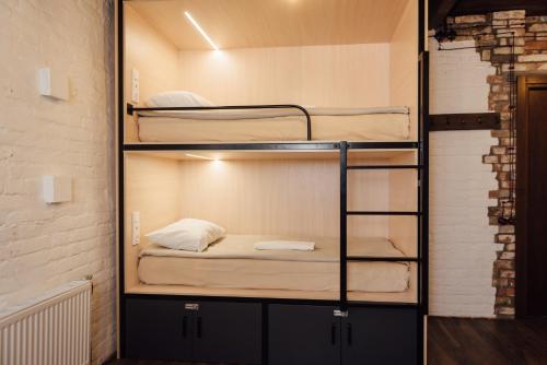 a room with two bunk beds in a building at Капсульний готель Добрий sleep&eat in Dnipro