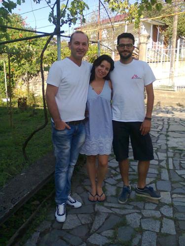 two men and a woman posing for a picture at Giorgi's Homestay in Kutaisi