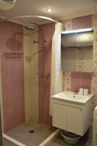 a bathroom with a toilet and a sink and a shower at Sea apartment / Апартамент до морето in Varna City