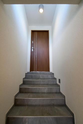 a set of stairs with a door in the background at Apartmenty u Šípků OSTRAVA in Vřesina