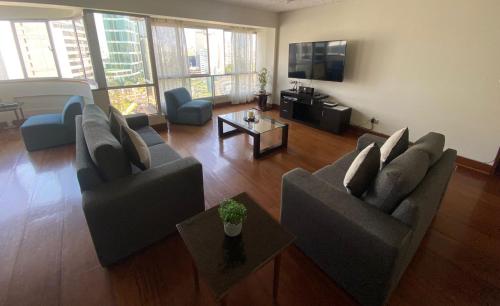 a living room with two couches and a tv at Oceanfront Miraflores Larcomar next to Marriott in Lima