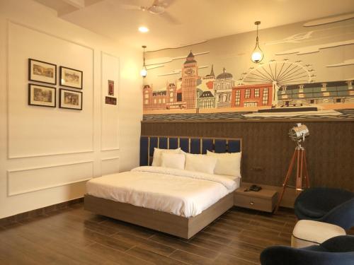 a bedroom with a bed and a building mural on the wall at Samardha Jungle Resort in Bhopal