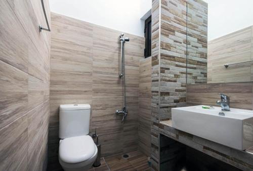 a bathroom with a toilet and a sink at Mojito Beach Rooms in Lachania