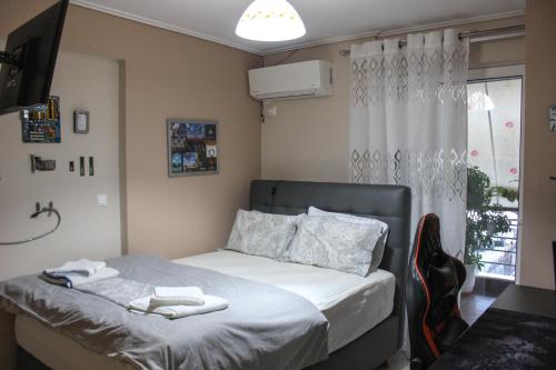 a bedroom with a bed with white towels on it at Premium Apartment In Chalkida in Chalkida