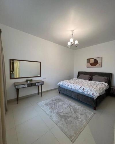 een slaapkamer met een bed, een spiegel en een tafel bij Amazing gateway in Jebel Sifah in Muscat