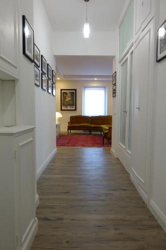 a hallway with a living room with a couch at APARTMENT ON THE SQUARE in Rome