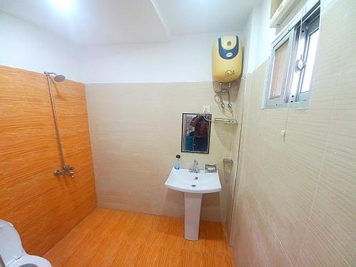 a bathroom with a white sink and a shower at Al fazal Tower in Rāmkot