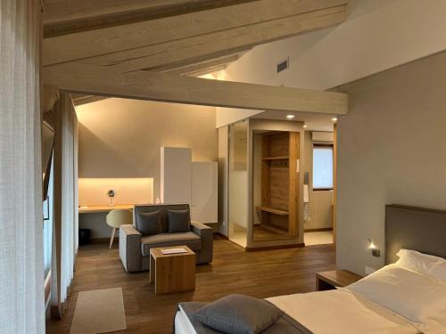 a bedroom with a bed and a couch and a table at Agriturismo Vedova in Valdobbiadene