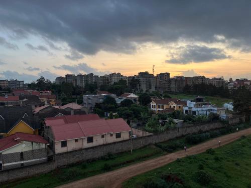 a view of a city with buildings and a fence at Rooftop Studio Apartment - Mirema in Nairobi