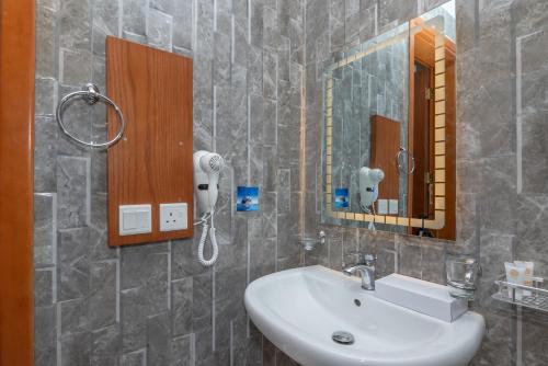 a bathroom with a sink and a mirror at فندق روز جدة 2 in Jeddah