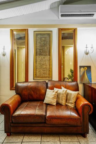 a brown leather couch sitting in a room at Hotel Lego in Platamonas