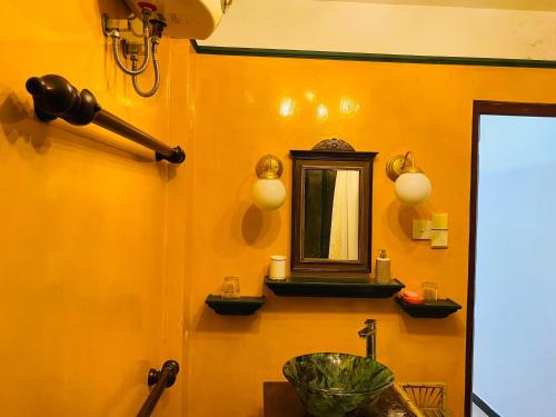 a bathroom with a sink and a mirror at Ganga Villa in Hikkaduwa