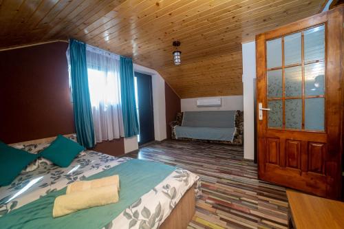 a bedroom with a bed and a door in a room at Complex Route 66 in Vama Veche
