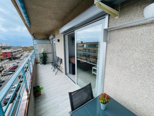 a balcony with a table and a view of a building at Apartamento Salvis Balcón in Platja d'Aro
