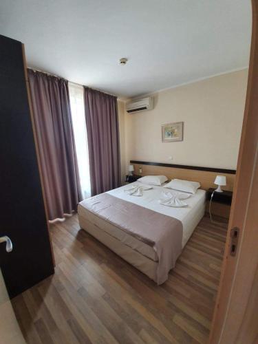 a bedroom with a large bed in a room at Obzor Beach Resort Exclusive sea view apartment in Obzor