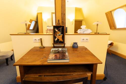 a room with a table with a book on it at Château de Tilly in Boissey-le-Châtel