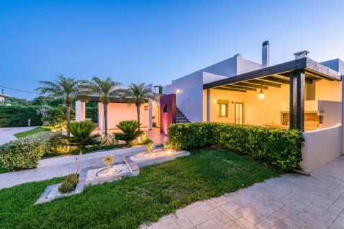 a house with a garden in front of it at Filerimos Oasis Villa in Ialysos