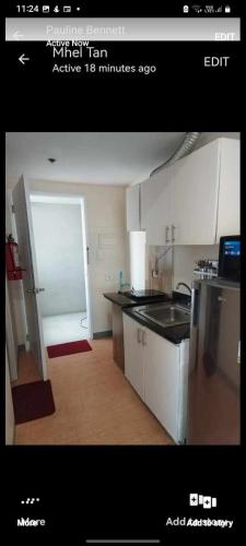 a kitchen with a refrigerator and a counter top at Sunvida Tower Condo 1 in Cebu City