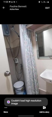 a bathroom with a shower and a toilet and a sink at Sarado do not book here please in Cebu City