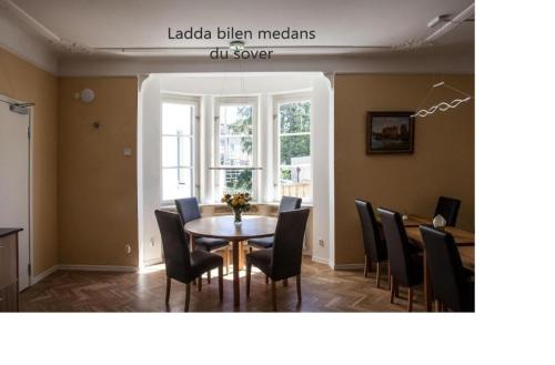 a dining room with a table and chairs at Södra Hotellet in Norrköping