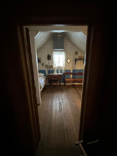 an open door to a bedroom with a bed and a table at Wilderness Center / Óbyggðasetur Íslands in Óbyggðasetur