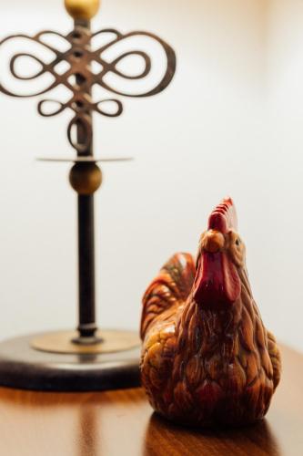 a wooden chicken sitting on top of a table at Hotel Picok in Ðurđevac
