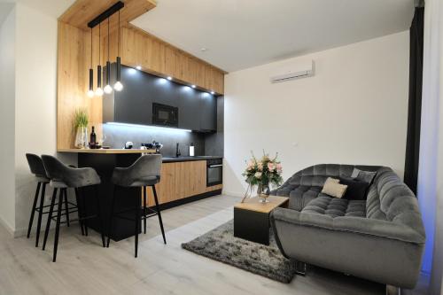 a living room with a couch and a kitchen at Solaris in Mostar