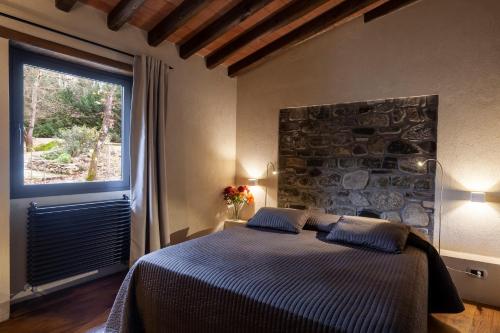 a bedroom with a bed and a large window at Ai Torchi Vecchi in Fivizzano