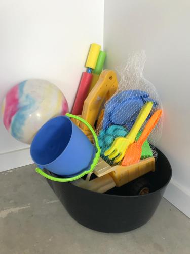 a black container filled with different types of toys at A Sanctuary at Denhams - Family & Pooch Friendly in Surf Beach