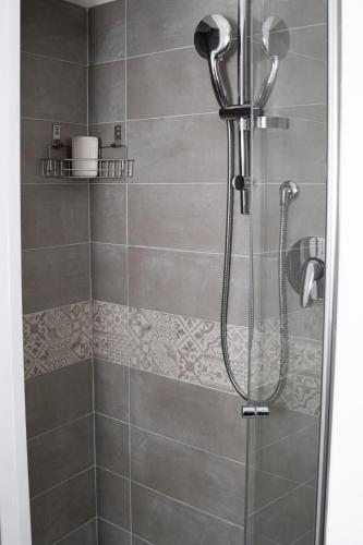 a shower stall with a shower head in a bathroom at La finestra sul mare Erice beach in Casa Santa