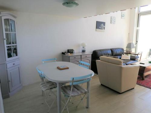 un salon avec une table et un canapé dans l'établissement Appartement Corail, vue plongeante sur la mer, à Fréjus