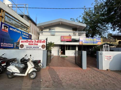 a scooter parked in front of a building at Aashirwad Residency Premium Vila in Ujjain