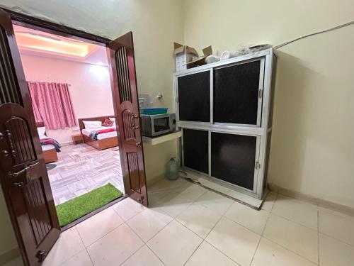 a kitchen with a door open to a living room at Aashirwad Residency Premium Vila in Ujjain