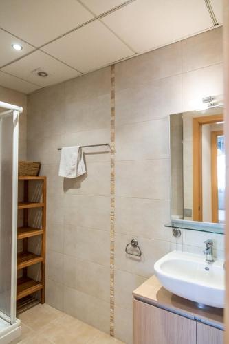 a bathroom with a sink and a mirror at Llevant 3 in L'Ampolla